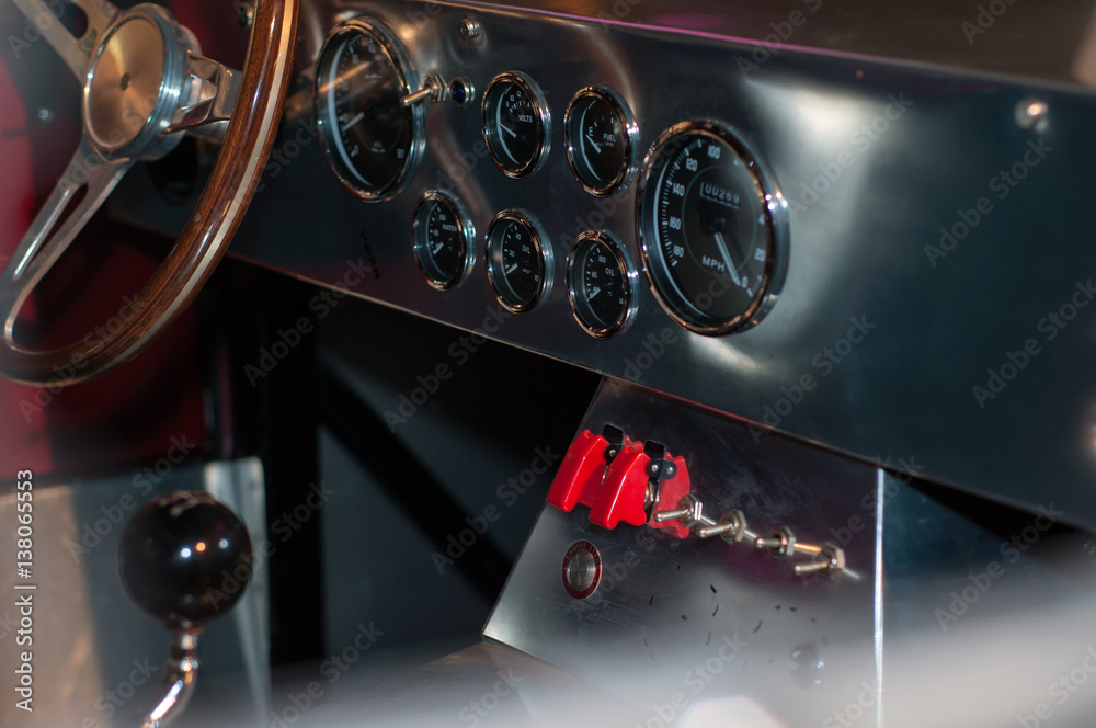 Classic race car dashboard with many gauges and steering wheel. Classic  race car interior. Stock Photo | Adobe Stock