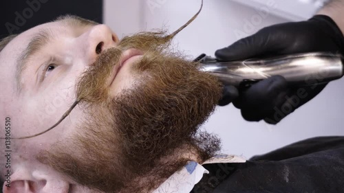 Men's hairstyling and haircutting in a barber shop or hair salon.