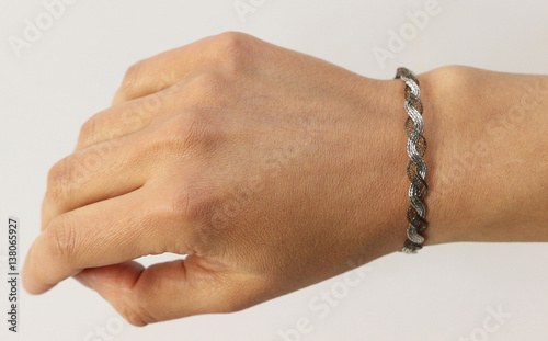 Bracelet on woman hand on white