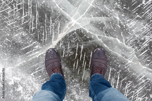 The view from the top to the frozen lake. Ice art. Dangerous to stand on the ice. photo