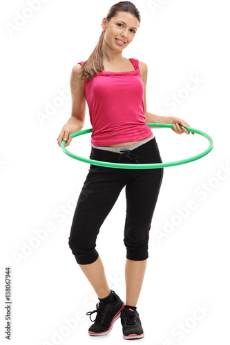 Female athlete exercising with a hula-hoop