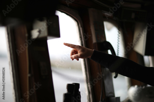 Locman hand shows the direction of movement of the ship wheelhouse boats