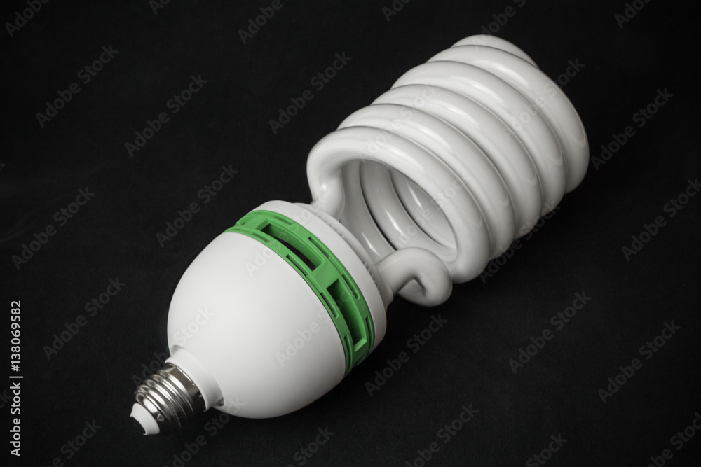 Big and small energy saving fluorescent light bulbs on black background Big and small energy saving fluorescent light bulbs on black background