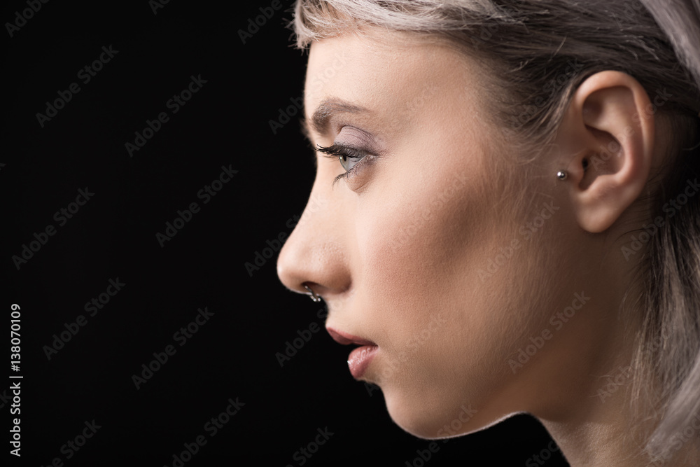 Profile portrait of beautiful young stylish woman on black Profile portrait of beautiful young stylish woman on black