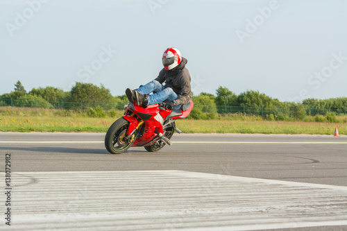 High chair drift on red stunt bike