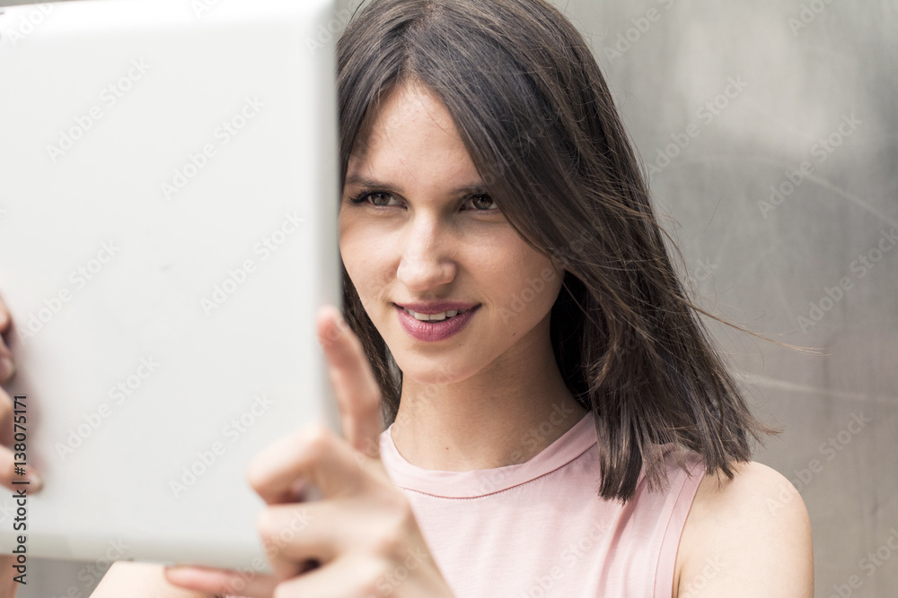 Portrait of young woman taking selfie with tablet Portrait of young woman taking selfie with tablet
