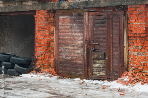 Old garage doors and tumbledown brick walls.