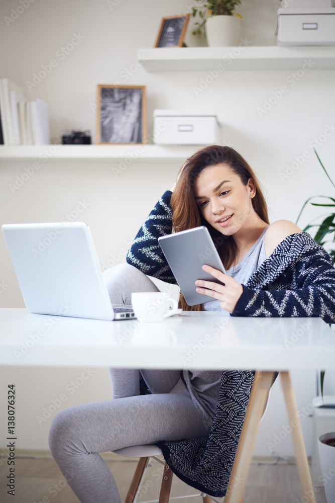 young woman reading using tablet at home young woman reading using tablet at home