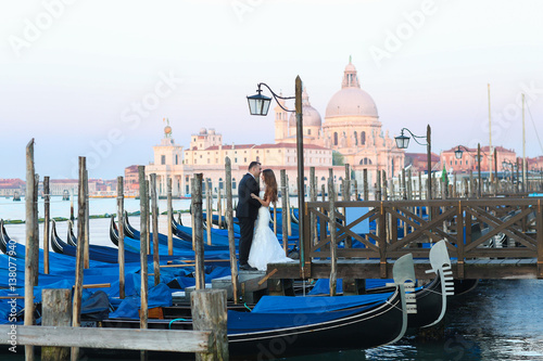 Groom and bride in Venice Italy near gondola