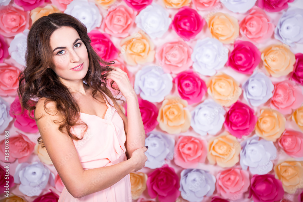 spring and summer concept - portrait of young beautiful woman over flowers wall spring and summer concept - portrait of young beautiful woman over flowers wall