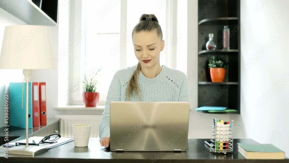 Happy woman working on new, silver laptop and stretching muscles, steadycam shot
Happy woman working on new, silver laptop and stretching muscles, steadycam shot
