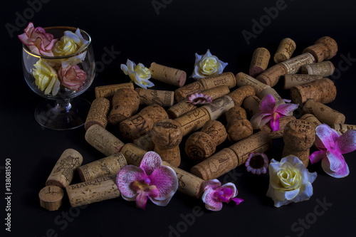 Wine corks with beautiful flowers isolatet on black background. A heart, love valentine day,