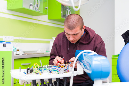 Medical repairman fixing equipment