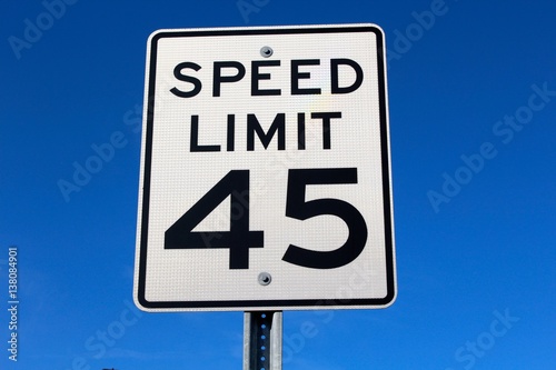 The speed limit sign with the blue sky as the background.