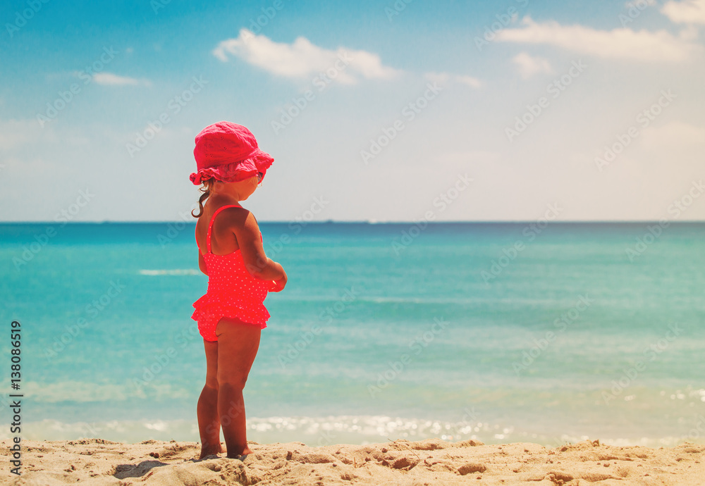 little girl looking at beach, tropical vacation concept little girl looking at beach, tropical vacation concept
