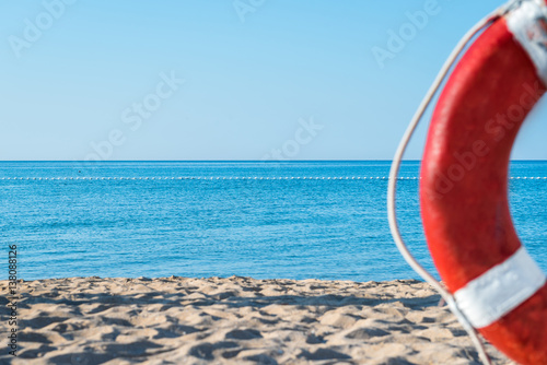 life preserver on a background of the sandy beach and the sea