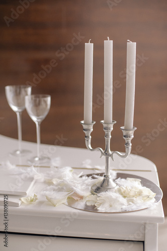 Composition with candlestick with candles and glasses photo