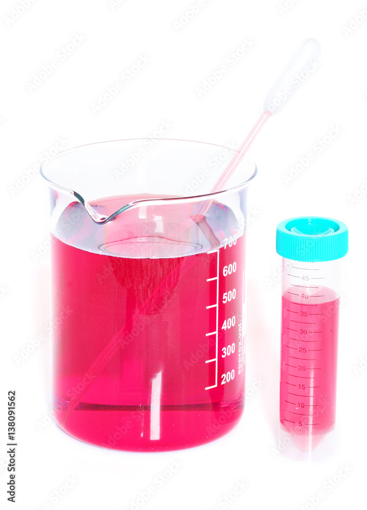 Chemical beaker with red chemicals dissolved in water and pipette Stock