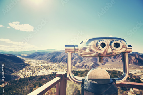 Color toned photo of binoculars looking out over a valley, selective focus, Glenwood Springs, Colorado, USA. photo