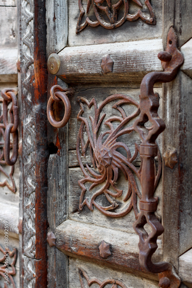 Old authentic wooden door with metal elements in Venice, Italy. Old authentic wooden door with metal elements in Venice, Italy.