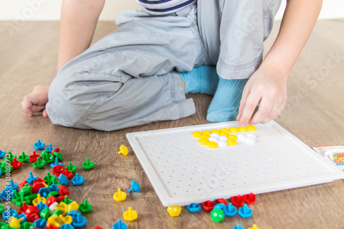 child collects mosaic