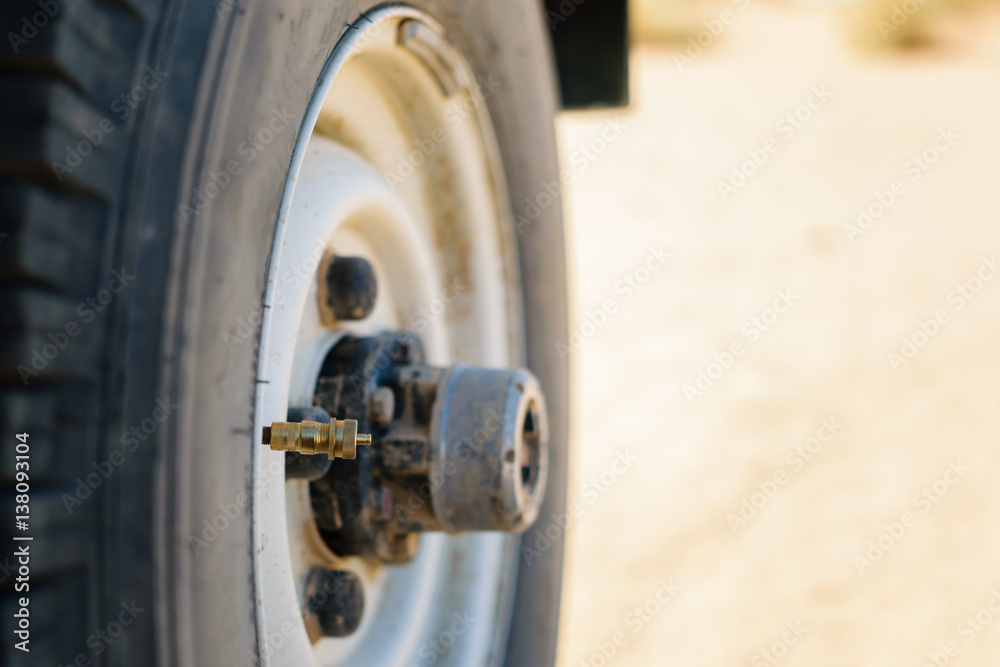Off-road tire with mounted tire deflator Off-road tire with mounted tire deflator