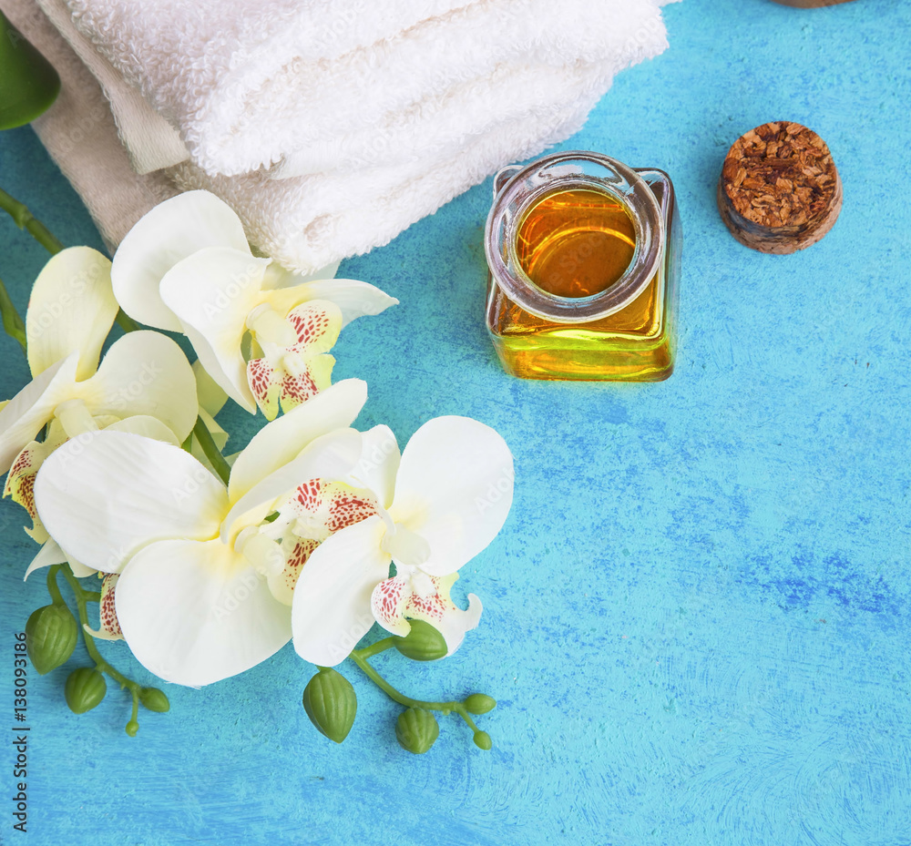Spa set with orchid, honey for skin treatments and cotton towels on painted wood Spa set with orchid, honey for skin treatments and cotton towels on painted wood