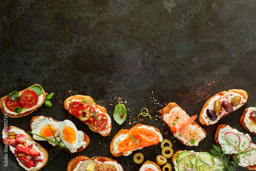 Border of fresh canapes with copy space for menu