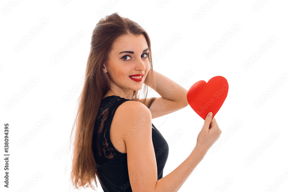 young cheerful brunette lady with red heart in hands smiling on camera isolated on white background. Valentines Day concept. young cheerful brunette lady with red heart in hands smiling on camera isolated on white background. Valentines Day concept.