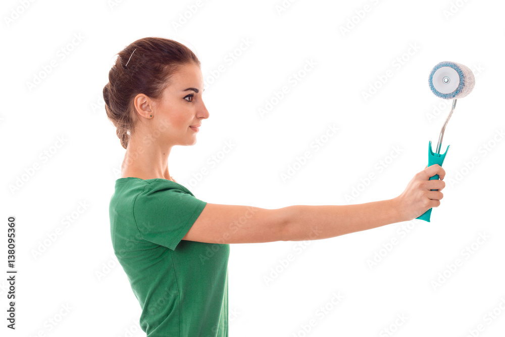 profeil of young pretty brunette woman builder in uniform with paint roller in hands make reovations isolated on white background profeil of young pretty brunette woman builder in uniform with paint roller in hands make reovations isolated on white background