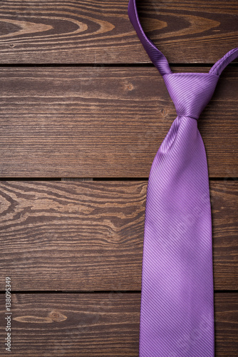 Wallpaper Mural Purple necktie on wooden table