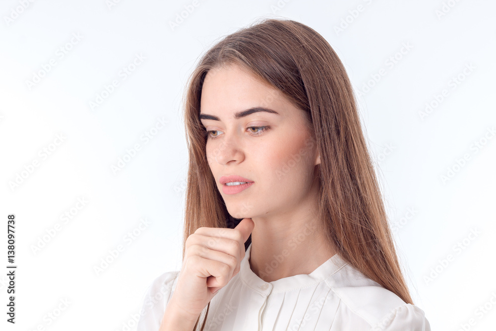 Portrait of a girl that thought and looks down isolated on white background Portrait of a girl that thought and looks down isolated on white background