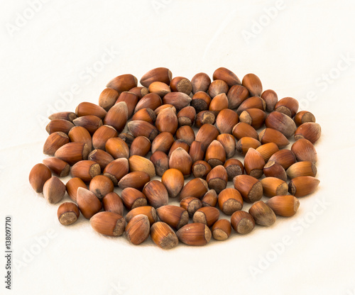 Group of raw hazelnuts on a white background