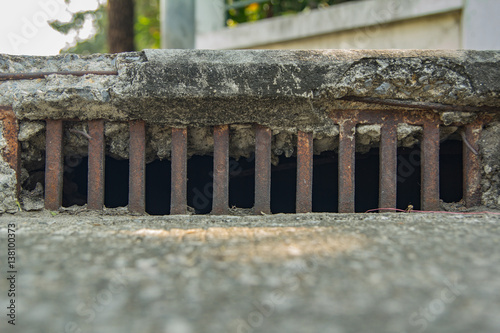 old vintage grille drain at footpath