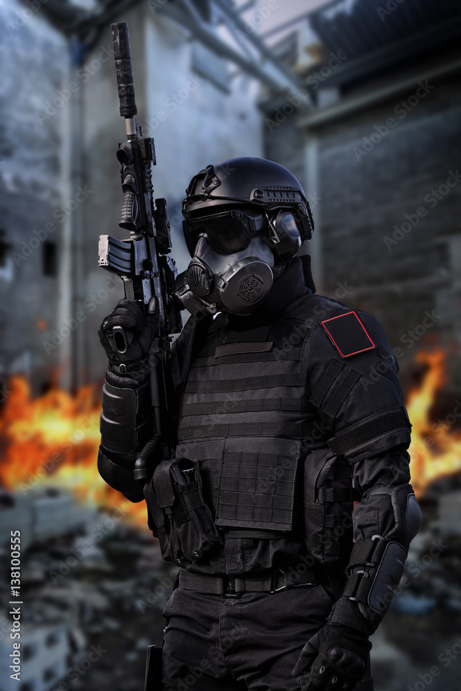 Futuristic soldier, patrolling in a building razed by fire. Futuristic soldier, patrolling in a building razed by fire.