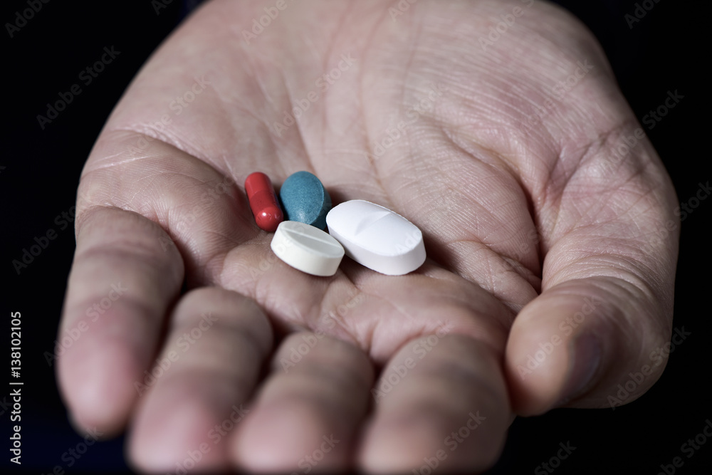 pills in the hand of a young man pills in the hand of a young man