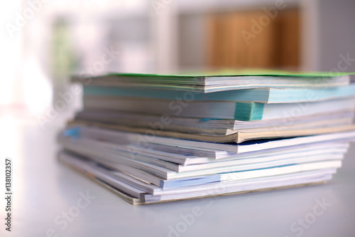 close up of stack of papers on white background