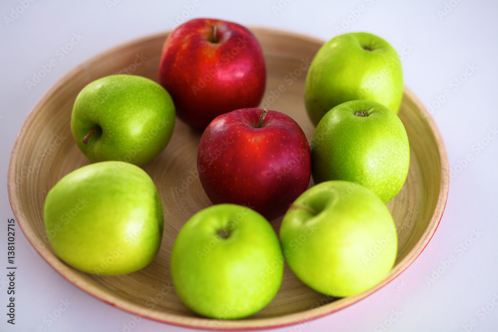 Still life arrangement of apples on a wooden platter Still life arrangement of apples on a wooden platter