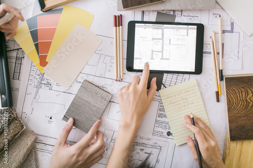 Overhead view of couple reviewing floorplan