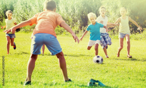 kids kicking football in park © JackF