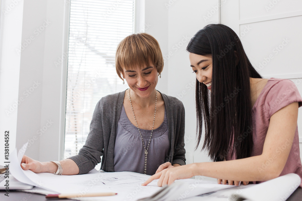 An interior designer reviews renovation plan with client
