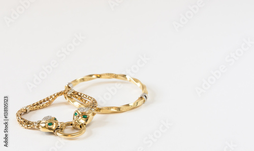 A few gold bracelets on white background. Woman's Jewelry.