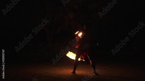 Indigenous Fijian man during a fire dance at nigh in Fiji