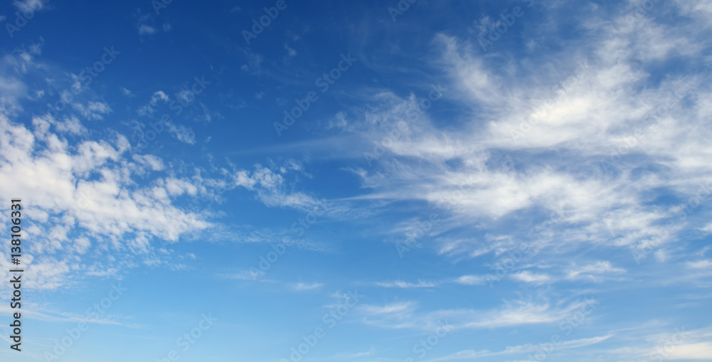 White cirrus clouds against the dark blue sky. White cirrus clouds against the dark blue sky.