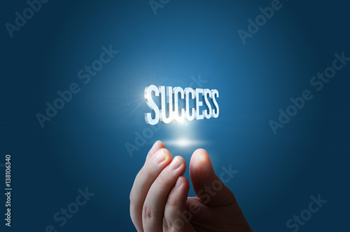 Success word in businessman hand. photo
