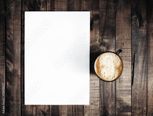 Blank letterhead and coffee cup on vintage wooden table background. Blank branding template. Blank stationery. Mockup for branding identity for placing your design. Top view.. Top view. photo