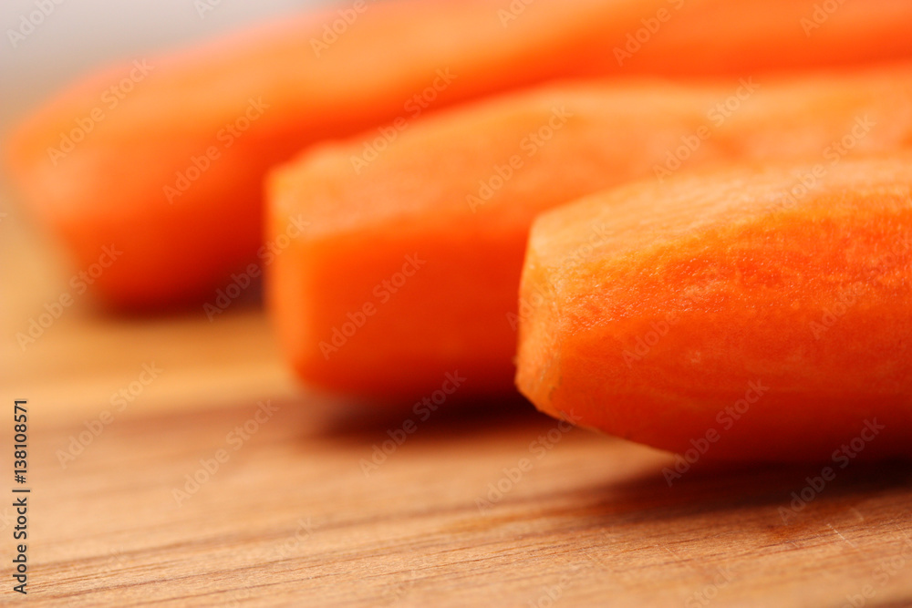 Peeled carrots on wooden chopping board. Peeled carrots on wooden chopping board.