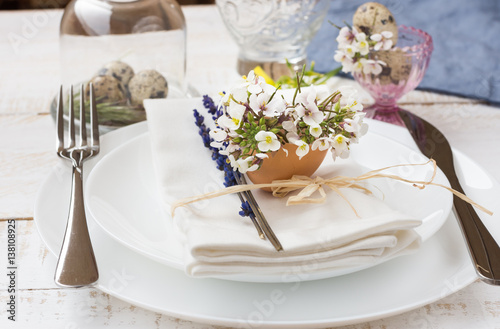 Romantic wedding table setting, lavender, white plates, napkin, flowers, Easter decoration, outdoors