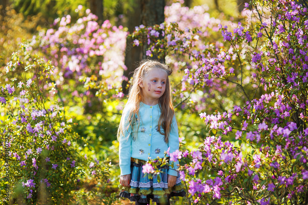 Adorable little girl in in blooming apple tree garden on spring day Adorable little girl in in blooming apple tree garden on spring day