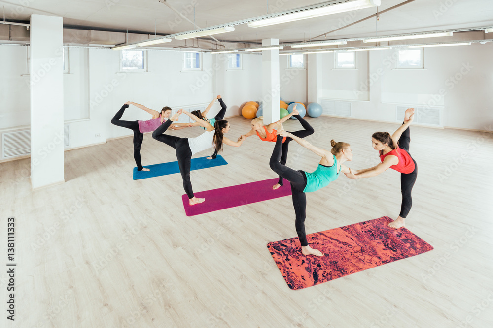 Fototapeta premium women are practicing yoga exercises in the studio. pair yoga concept.